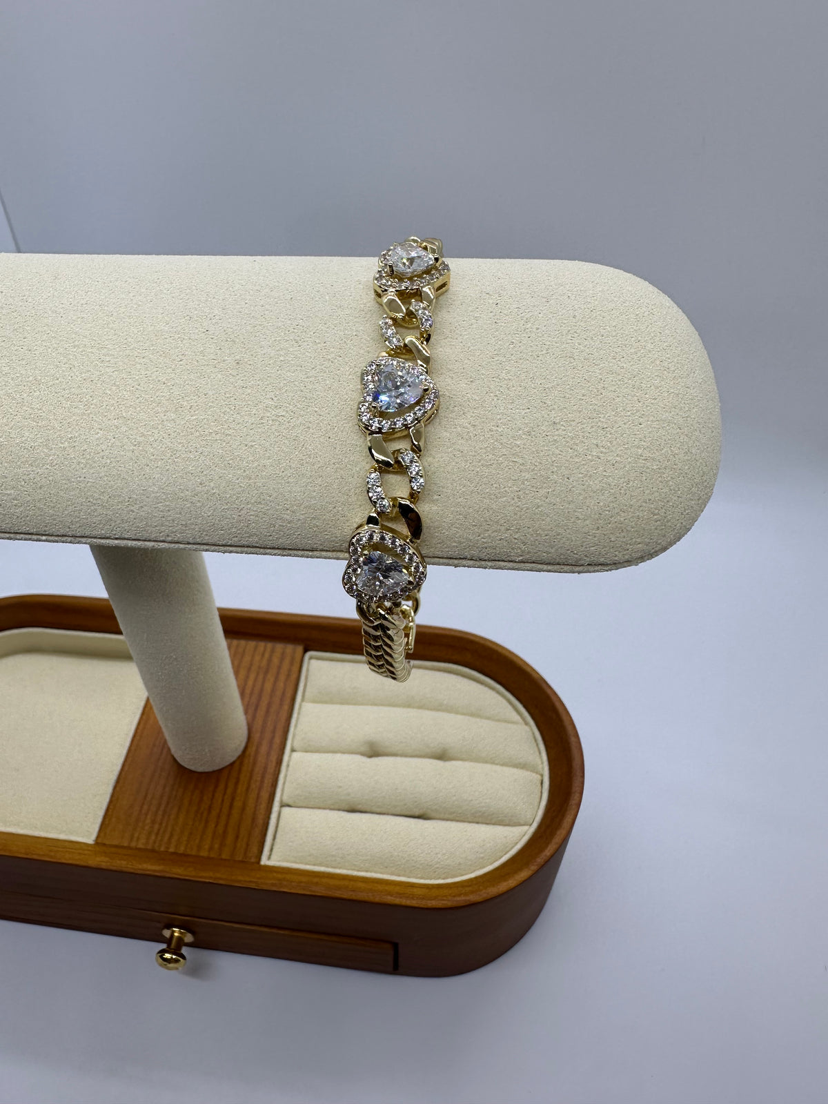 Gold-plated bracelet with heart and infinity charms - worn on the wrist