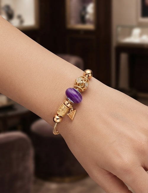 Elegant gold-plated bracelet with purple crystal charm - front view